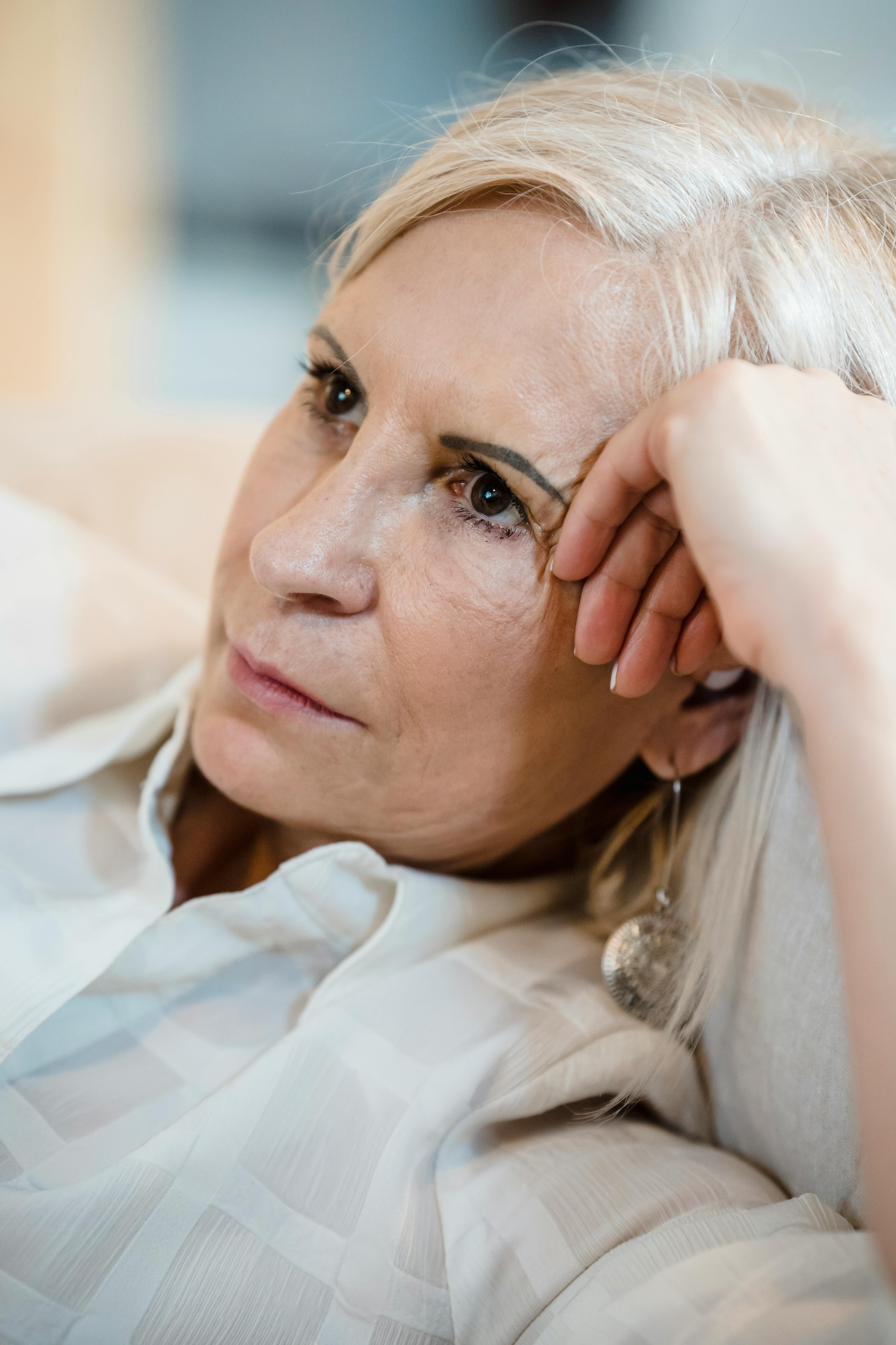 Woman over 40 looking thoughtful and reflective - Hello Heart Coaching helps women reconnect with themselves.